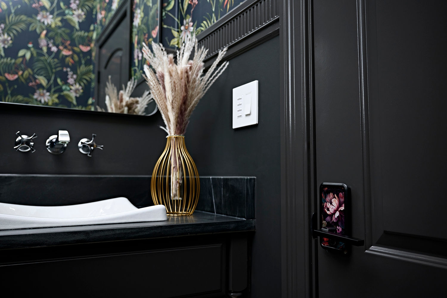Uniquely styled powder room with a custom floral door handle.