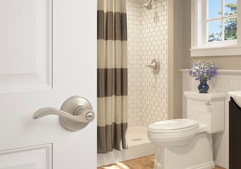 Modern bathroom with silver door lever that locks for privacy.